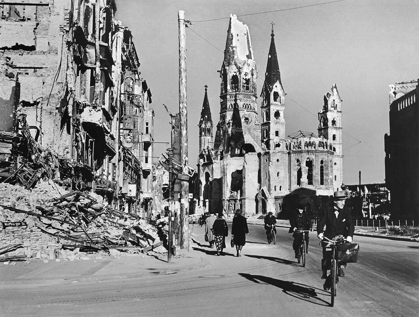 Robert Capa, Gente lungo una strada fiancheggiata da edifici distrutti, Berlino, Germania, agosto 1945