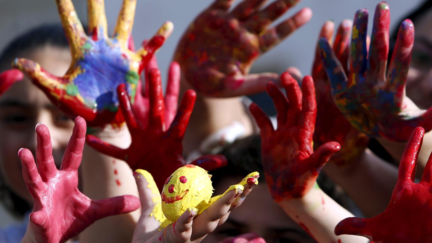 Ancora dalle Filippine, bambini con le mani colorate e un piccolo uovo pasquale