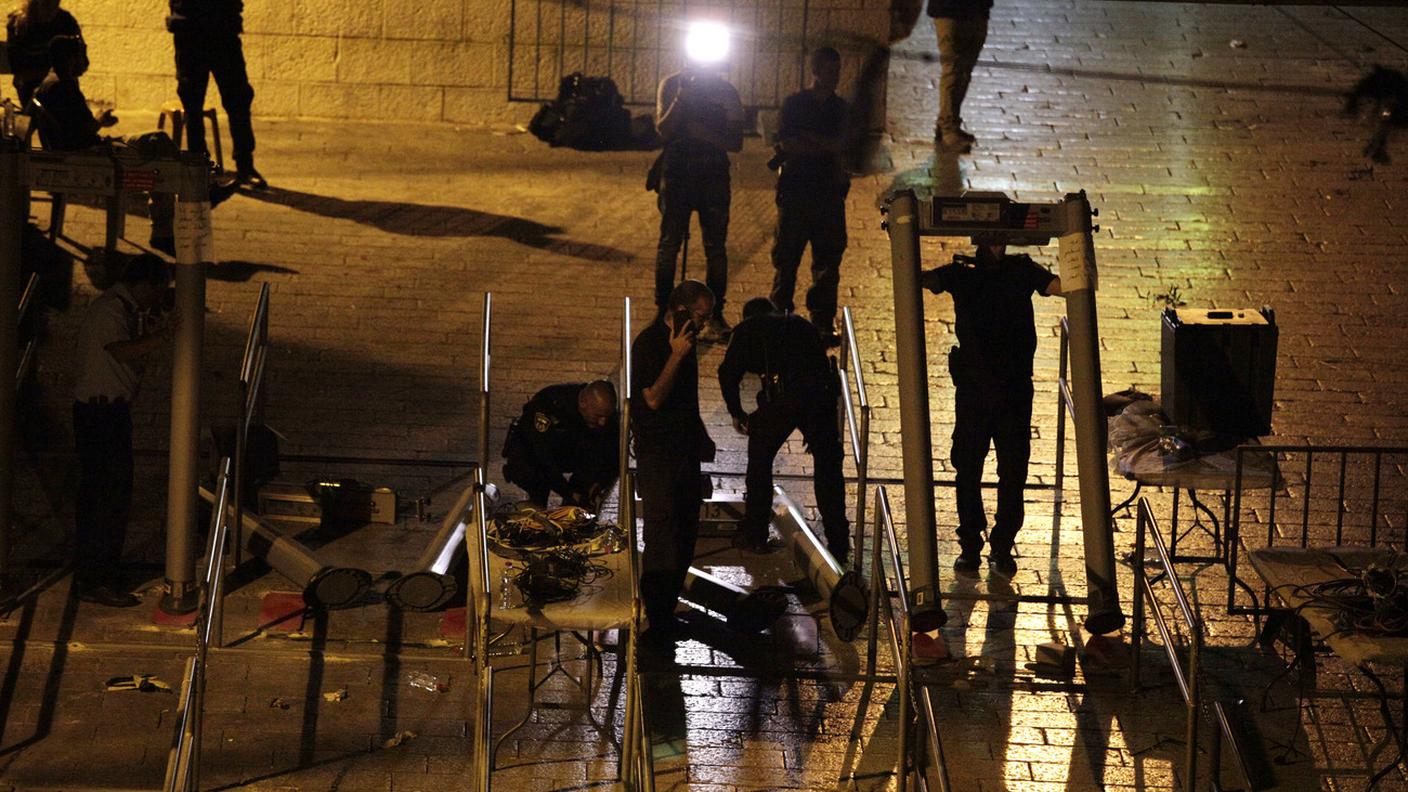 Agenti israeliani rimuovono i metal detector dagl'intressi alla Spianata delle Moschee di Gerusalemme.