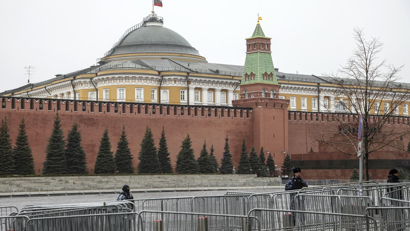 Bandiera russa a mezz'asta sul Cremlinoi, in una Piazza Rossa deserta e presidiata