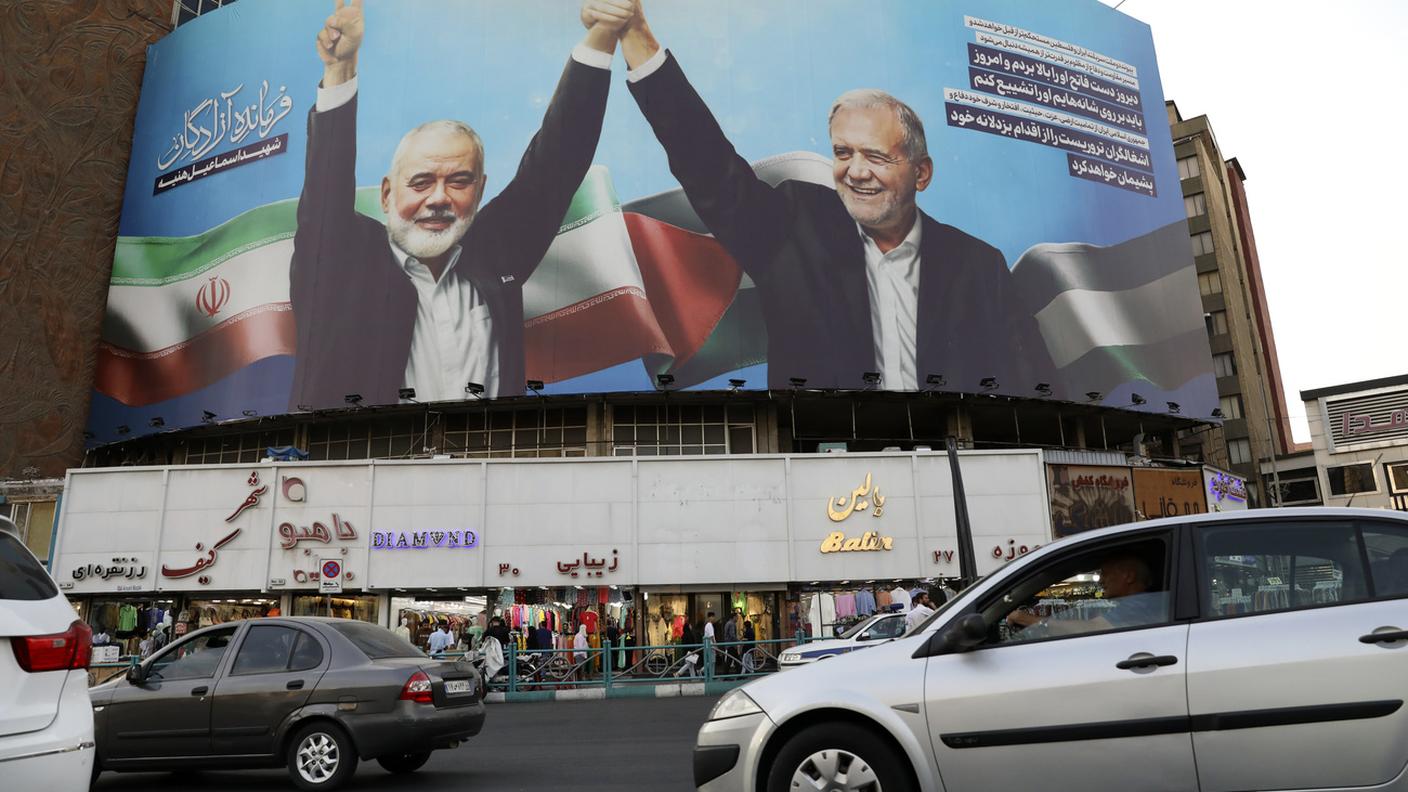 Nel centro di Teheran un'immagine del neopresidente iraniano Pezeshkian (a destra) con il leader assassinato di Hamas Haniyeh