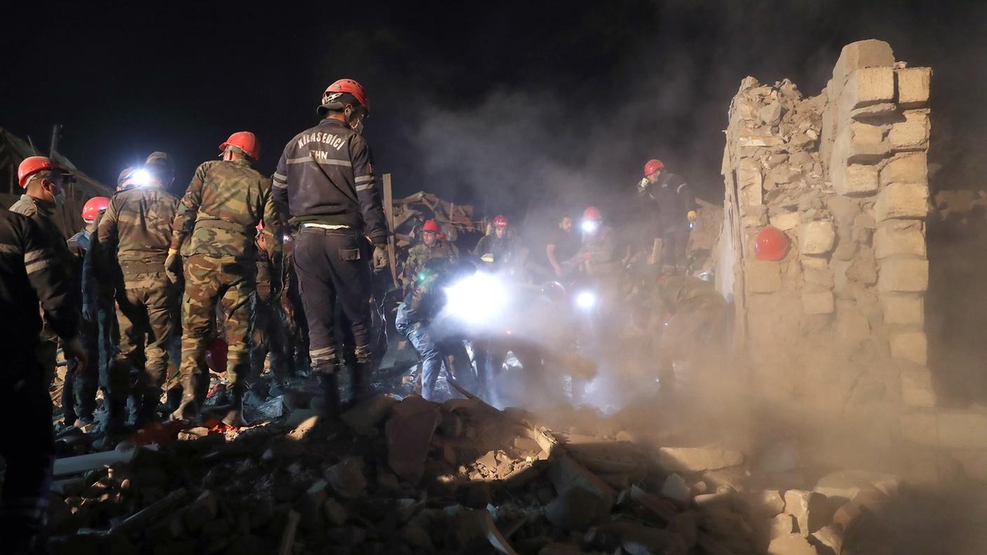 Soccorritori al lavoro fra le macerie di una località coinvolta nel conflitto