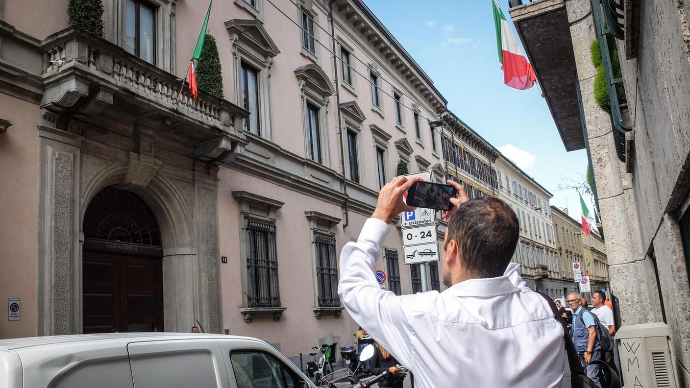 Un passante scatta una foto alla sede della Giorgio Armani S.p.A a Milano
