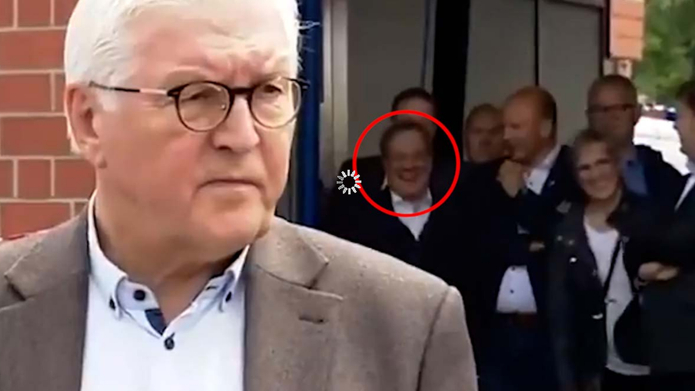 Armin Laschet ride (nel tondo, sullo sfondo) mentre il presidente tedesco Steinmeier parla delle vittime dell'alluvione