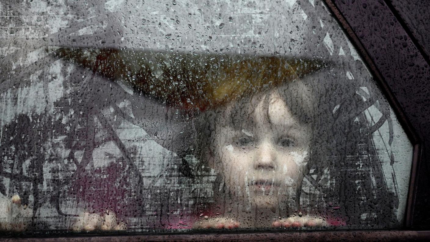 Un bimbo ucraino in fuga guarda dal finestrino di un'auto dopo essere arrivato in Polonia