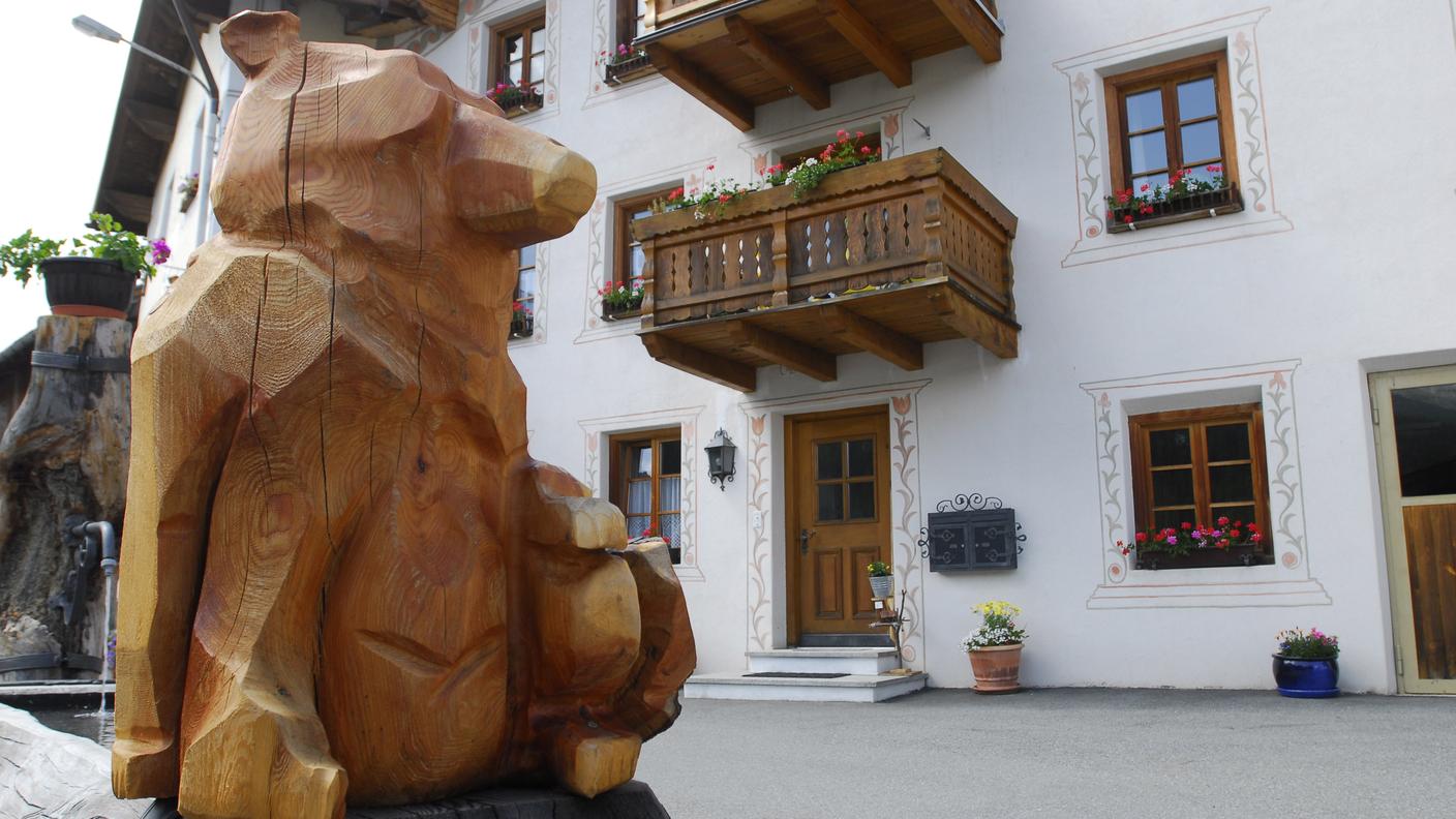 La scultura di un orso nel centro del paese di Tschierv in Val Monastero