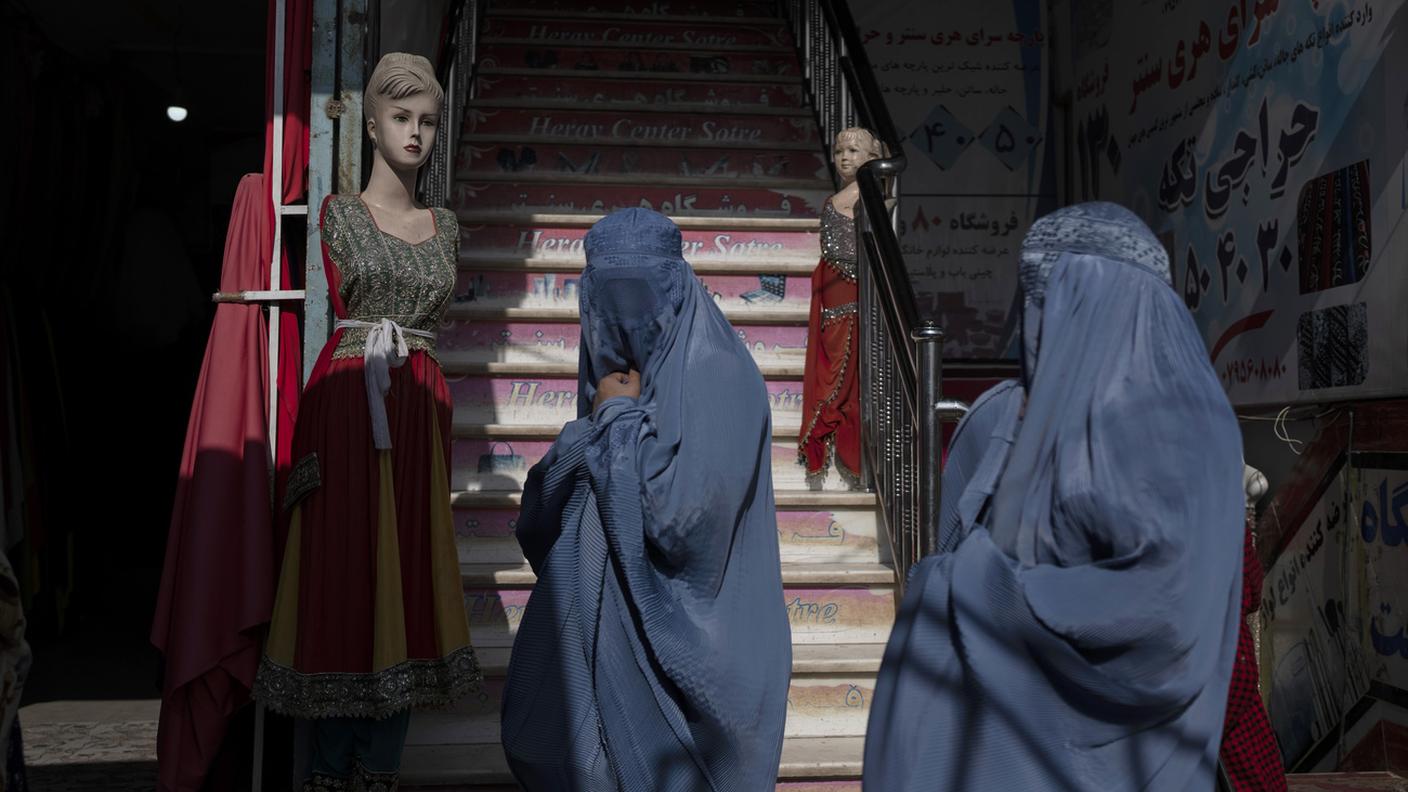 Due donne afghane camminano per strada indossando il Burka